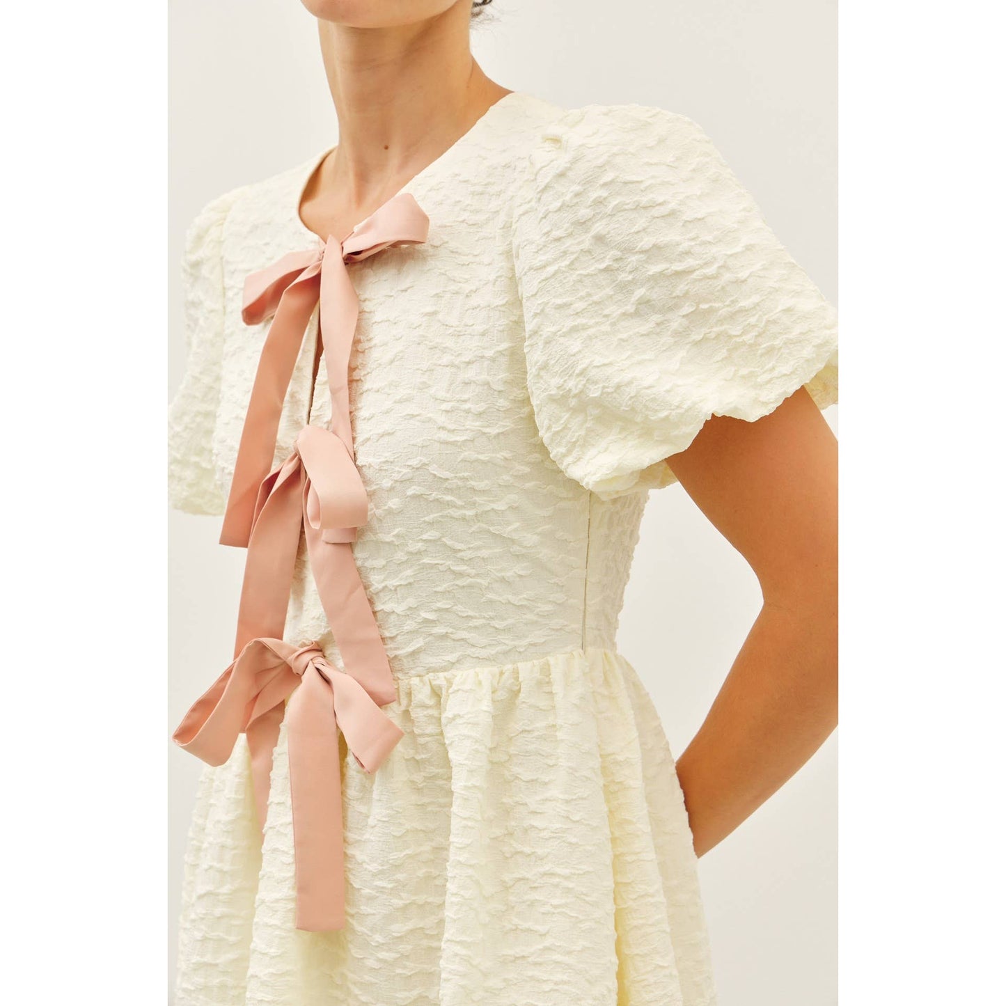 BUBBLE TEXTURED BOW TIE FRONT MINI DRESS WITH BUBBLE SLEEVES: BUTTER CREAM